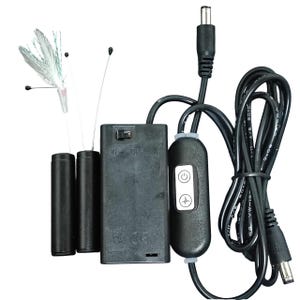 May include: A black battery-powered light kit with a control module and power cord. The kit includes a battery pack, three black cylindrical batteries, and a bundle of fiber optic strands with white and silver tips. The control module has power and pulse buttons.
