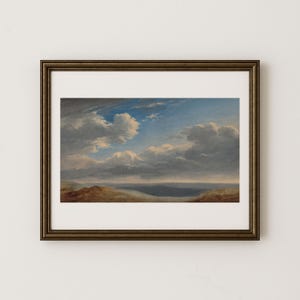 May include: A framed landscape painting depicts a dramatic sky with fluffy white clouds against a blue backdrop. The artwork features a dark, muted color palette, with a hint of land in the foreground. The frame is a dark, metallic bronze color.