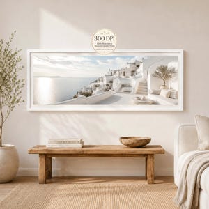 Könnte beinhalten: Ein Panorama-Wandkunstdruck in einem weißen Rahmen, der eine mediterrane Küstenszene mit weißen Gebäuden, Steintreppen und einem ruhigen Meer unter einem hellen Himmel zeigt. Ein kreisförmiges Abzeichen oben zeigt den Text 300 DPI High-Resolution Museum Quality Prints.