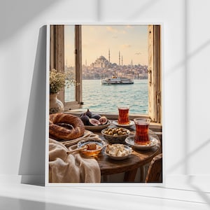 May include: A framed wall art print depicting an open window view of a city skyline with a mosque and a ferry on the water. On a wooden table in the foreground, there is a simit bread, figs, olives, honey with a dipper, and two glasses of tea.