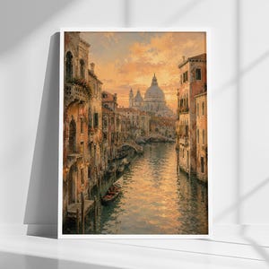 May include: A framed painting depicts a Venetian canal scene at sunset. The artwork showcases buildings with warm, earthy tones lining the waterway, with a domed church in the distance. A gondola is visible.