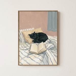 May include: A framed art print showing a black cat asleep on a bed with an open book. The bed has striped bedding and a yellow pillow. The background features a pink wall and a blue curtain.