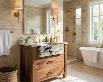 May include: A luxurious bathroom with a wooden vanity featuring a marble sink with black veining. The room includes a large mirror, sconce lighting, a glass shower, and a freestanding bathtub. The colour palette is neutral with gold fixtures and a woven basket.