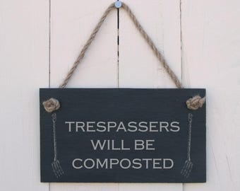 Hanging sign 'trespassers will be composted'