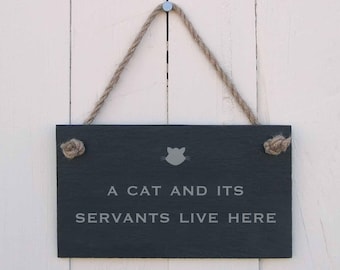 Hanging sign 'a cat and its servants live here'
