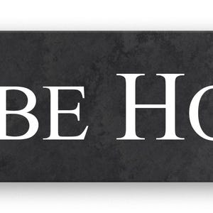May include: A rectangular sign featuring the text "GLEBE HOUSE" in a white serif font. The sign has a dark grey, textured background, possibly stone or a similar material. The sign is designed for mounting.