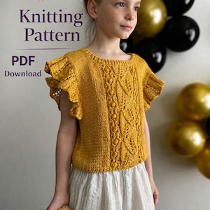 May include: A young person wearing a mustard yellow knitted top with ruffled sleeves and a detailed central pattern. The image includes text that says "Knitting Pattern PDF Download". The background features balloons.