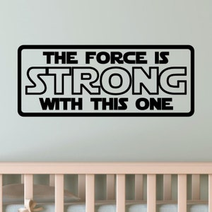 May include: Black and white wall decal with the text "The Force is Strong With This One".
