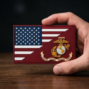 May include: A rectangular patch featuring the American flag and the emblem of the United States Marine Corps. The flag is on the upper left, with the Marine Corps emblem on the lower right. The emblem includes an eagle, globe, and anchor.