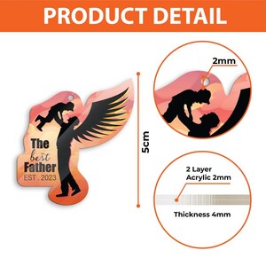 Puede incluir: Adorno decorativo con la silueta de un padre sosteniendo a un ni&ntilde;o, con alas de &aacute;ngel. El texto dice "The best Father EST. 2023". El adorno mide 5 cm de alto y est&aacute; hecho de acr&iacute;lico de 2 capas, 2 mm de grosor, con un grosor total de 4 mm.