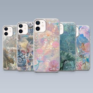 May include: Five clear phone cases with mermaid-themed designs. The cases feature illustrations of seashells, mermaids, and aquatic elements in pastel colors. One case has the word "Merma" printed on it.