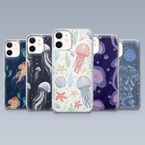 May include: Five phone cases with colorful jellyfish designs. The cases feature various patterns, including detailed illustrations of jellyfish, starfish, and seashells in shades of blue, orange, and white. The cases are clear with a protective design.