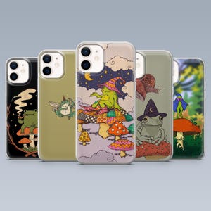 May include: Five phone cases with fantasy-themed illustrations. The cases showcase colourful designs of frogs, mushrooms, and other whimsical elements. Each case has a unique design, with a variety of colours and styles.