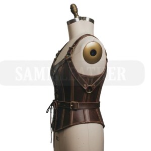 May include: A brown leather corset with adjustable straps and a belt. The corset features a structured design with vertical seams and metal hardware. The garment is displayed on a mannequin, showcasing its form and detailing. The overall aesthetic suggests a vintage or steampunk style.