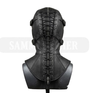 May include: Black leather hood with a zipper and lace-up back. The hood has a high collar and is secured with buckles. The text "SAMM HER" is visible on the image.