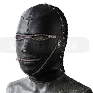 May include: Black leather hood with multiple zippers and lace-up detailing on the sides. The hood covers the entire head and face, with openings for the eyes and mouth. The zippers are silver-toned and run horizontally across the face.