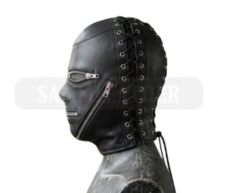 May include: Black leather hood with a zippered mouth and eye openings. The hood features a lace-up back and is designed to cover the entire head and neck. The mask is shown in profile against a white background.