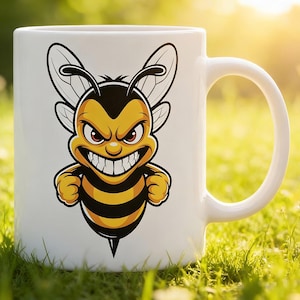 May include: White ceramic mug featuring a cartoon bee with a menacing expression. The bee is yellow and black with a detailed design, including wings and clenched fists. The mug has a curved handle and is set against a blurred green background.
