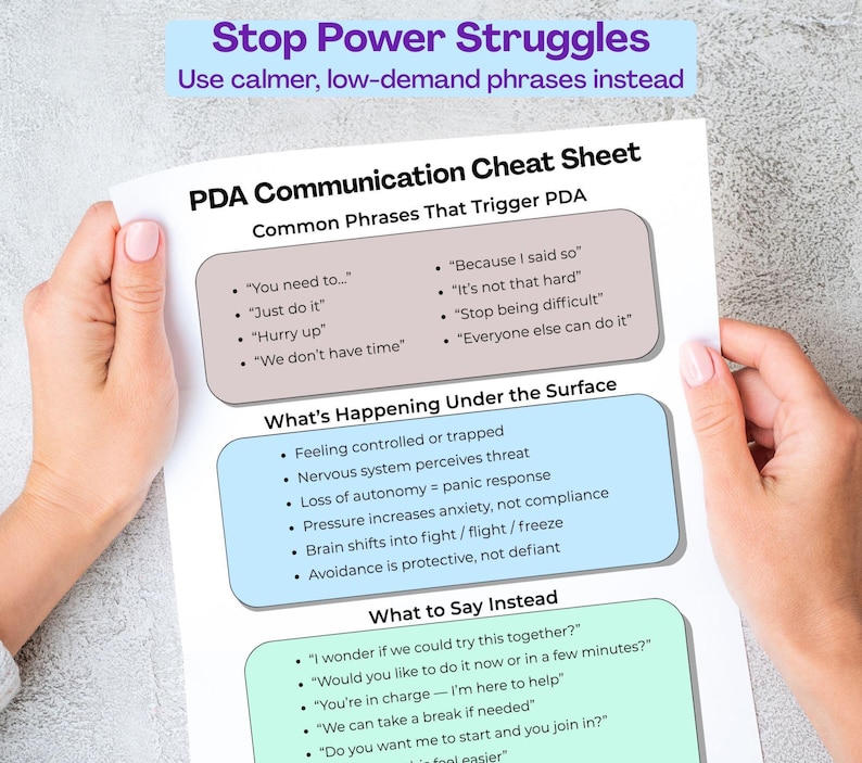 Hands holding PDA communication cheat sheet printable showing trigger phrases and supportive alternatives