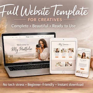 May include: A laptop, tablet, and smartphone display a website template with the text "Full Website Template for Creatives." A camera, pen, and notepad are also on the wooden surface. The website displays "Welcome to My Portfolio."