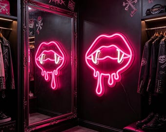 May include: A neon pink sign in the shape of dripping lips with fangs, mounted on a black wall. The sign is reflected in a large framed mirror. The word "cityneo" is above the mirror. The room has black walls and a dark floor.