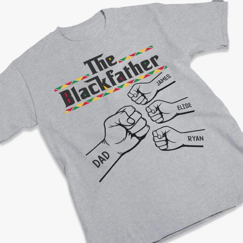 May include: A gray t-shirt with the text "The Blackfather" in black, red, green, and yellow. Below the text are four fists with the names "DAD", "JAMES", "ELISE", and "RYAN" printed on the shirt.