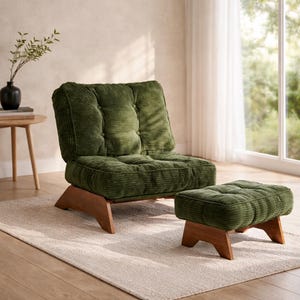 May include: A green corduroy armchair and matching ottoman with wooden legs sit on a neutral rug. The chair has a tufted back and seat. A small side table with a black vase and greenery is in the background.