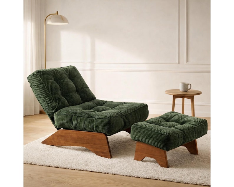 May include: A green corduroy lounge chair and matching ottoman set. The chair has a tufted back and seat, with a wooden base. The ottoman is a low, square shape with a matching wooden base. The set is placed on a white rug.
