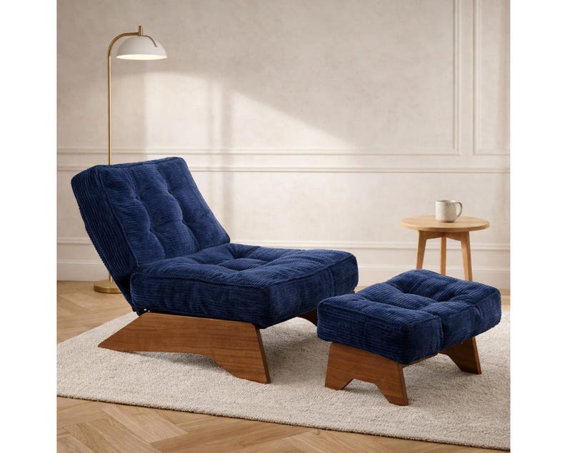May include: A navy blue corduroy lounge chair and ottoman set. The chair has a tufted back and seat, and both pieces have wooden bases. A small side table and a floor lamp are also in the image.