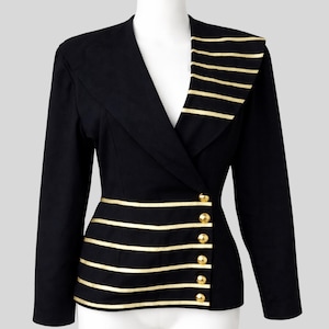 Black women’s asymmetrical blazer with gold stripes and buttons, featuring a tailored fit and modern military-inspired design on a mannequin.