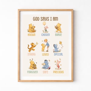 May include: A framed print with the text "GOD SAYS I AM" above illustrations of Winnie the Pooh characters. Each character is paired with a positive affirmation like "KNOWN", "CHOSEN", and "BRAVE". The frame is a light brown color.