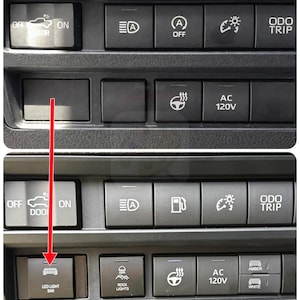 May include: Close-up of a black dashboard with illuminated buttons. The buttons include controls for lights, heated seats, and AC. The text "LED LIGHT BAR" is visible on one button.