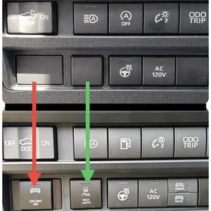 May include: A close-up of a car dashboard with various black buttons. The buttons include controls for lights, AC, and other vehicle functions. The text "LED LIGHT BAR" and "ROCK LIGHTS" are visible on the buttons.