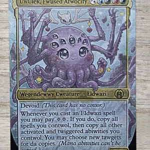 May include: A rectangular trading card titled UwUlek, Fwused Atwocity featuring a purple, multi-eyed, multi-armed creature with a cute expression. The card includes text describing game abilities, mana symbols, and a power/toughness rating of 2/5.