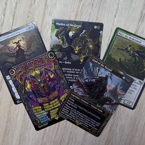 May include: A collection of five Magic: The Gathering trading cards featuring various fantasy illustrations and text, including cards titled Sauron, Lord of the Rings, Warden of the Grove, Rhys the Redeemed, and Lord of the Nazgûl, displayed in a fan arrangement.