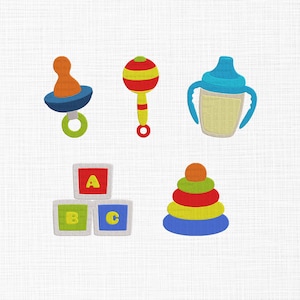 May include: A collection of embroidered baby toys, including a pacifier, rattle, baby bottle, alphabet blocks, and a stacking ring toy. The toys are in bright colors like blue, orange, red, green, and yellow, set against a white background.