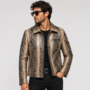 May include: A long-sleeve jacket featuring a tan and black snakeskin pattern, a pointed collar, a front zipper closure, and two zippered pockets on the chest and waist. The jacket is worn over a plain black shirt and black pants.