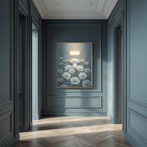 May include: A framed artwork featuring a sheep wearing a golden crown, surrounded by white flowers. The artwork is set against a soft, glowing background. The frame is gold, and the artwork is displayed in a hallway with blue walls and a wooden floor.