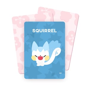 May include: A blue card featuring the word "SQUIRREL" and a cartoon squirrel illustration. The squirrel is white with blue accents, yellow cheeks, and a red tongue. Two pink cards with floral designs are in the background.