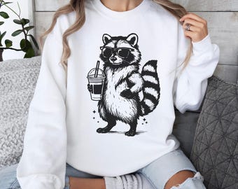 Funny Raccoon Drinking Iced Coffee Shirt: Animal Meme Graphic Tee