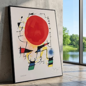 Puede incluir: Impresión artística enmarcada con un gran círculo rojo, formas negras y acentos coloridos. La obra de arte incluye elementos amarillos, azules y verdes sobre un fondo blanco. La impresión está en un marco negro.