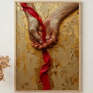 Puede incluir: Una obra de arte enmarcada con un fondo dorado texturizado y un par de manos sosteniendo una cinta roja vibrante. La pintura tiene una paleta de colores cálidos y una calidad táctil tridimensional, creando una sensación de profundidad y emoción.