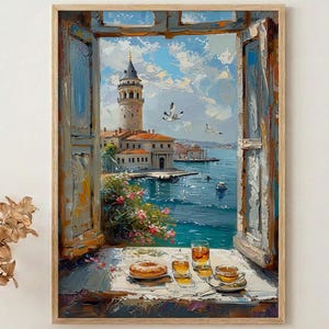 May include: A framed oil painting depicts a scenic view through an open window. The artwork showcases a coastal city with a prominent tower, blue water, and a bright sky. A table in the foreground holds a pastry, drinks, and teacups, adding a touch of everyday life.