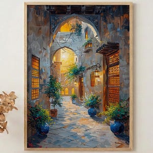 May include: A framed art print depicting a sunlit alleyway with arched doorways and stone walls. The artwork features potted plants, blue pots, and warm lighting, creating a sense of depth and tranquility. The color palette includes shades of beige, blue, and yellow.