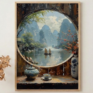 Puede incluir: Una pintura de paisaje enmarcada representa una serena escena fluvial con montañas al fondo. Una ventana redonda enmarca la vista, con una tetera, una taza de té y un jarrón en primer plano. La obra de arte está en un marco de madera.