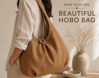 Puede incluir: Un bolso hobo de color marrón sólido con una sola correa para el hombro y un pequeño cierre de botón en la parte superior central. El texto MAKE YOUR OWN BEAUTIFUL HOBO BAG está impreso en letras marrón oscuro sobre una línea decorativa.