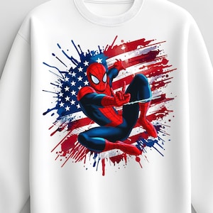 Könnte beinhalten: Ein weißes Sweatshirt mit Rundhalsausschnitt und einer Grafik des Superhelden Spider-Man in hockender Pose. Die Figur ist in Rot und Blau gehalten und vor einem stilisierten, farbgespritzten Hintergrund der amerikanischen Flagge in Rot, Weiß und Blau abgebildet.