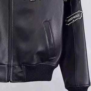 May include: Black leather jacket with a ribbed hem and cuffs. Features a patch on the chest with the text "NY ESTABLISHED 1975". White decorative stitching accents the sleeves. Includes a front pocket.
