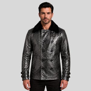 May include: A silver and black double-breasted jacket with a snakeskin pattern. The jacket has a black faux fur collar and black buttons. The sleeves have buttoned cuffs. The jacket is worn over black pants.
