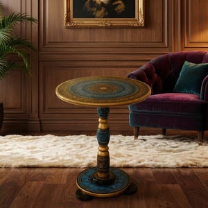 May include: A decorative side table with a round top featuring a gold and teal design. The table has a teal and gold pedestal base and is set on a fluffy rug. A purple armchair with a teal pillow sits nearby, with a floor lamp to the right.